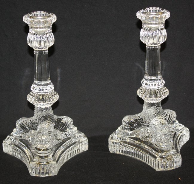 Pair of stamped Tiffany & Co single candle sticks with: mythological dolphins 8 1/4"h x 4 1/2"l
