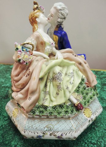 Dresden centerpiece compote: Dresden porcelain centerpiece compote depicting kissing couple with flowers. 13"H x 11"W x 11"D