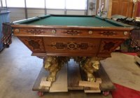 Brunswick pool table: Brunswick pool table with lion legs, inlay, and 4 slates. 38"H x 55"W x 101"L