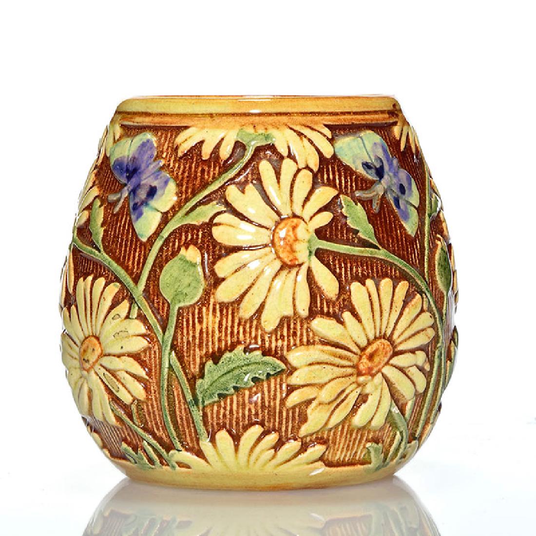 Weller Selma vase, daisies, butterflies, 4 3/8 inches: Weller Selma vase with molded daisy and butterfly design. Impressed WELLER on the bottom in block letters. There is faint overall crazing. Height is 4 3/8 inches.