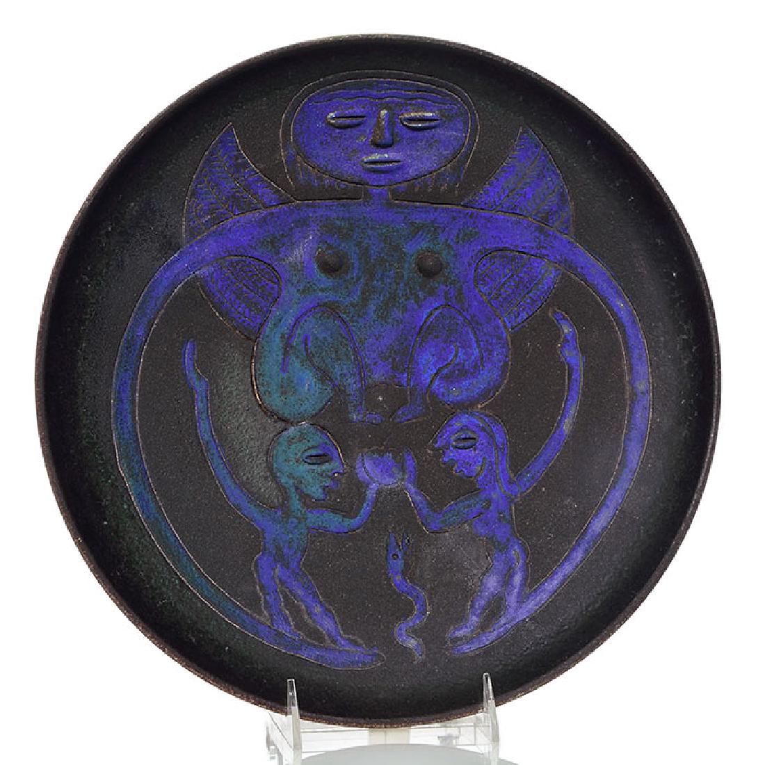 Scheier fertility charger, 2 3/8 x 12 3/4 inches: Edwin and Mary Scheier charger with embossed and incised fertility figures and covered with black, purple, blue and green mat glazes. Incised Scheier 90 on the bottom. There are firing separations tha