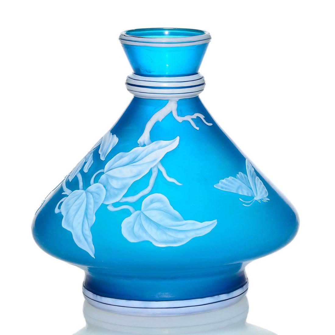 Thomas Webb & Sons cameo vase, floral, butterfly,6 1/2": Thomas Webb & Sons English cameo pedestal vase in Prussian blue with the visitation of a large butterfly to a vine with a clematis blossom. Measures 6 1/2 inches by 7 inches across. Unmarked. Decorati