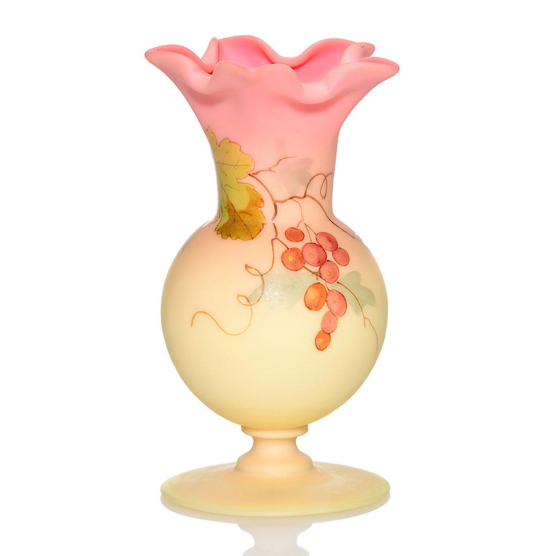 Thos. Webb & Sons Queens Burmese vase, berry, 4 7/8": Thomas Webb & Sons Queens Burmese footed vase with fold-in star rim and berry and vine decoration over an acid finish. Height 4 7/8 inches. Stamped with the Webb Queens Burmese logo. Not often seen fo