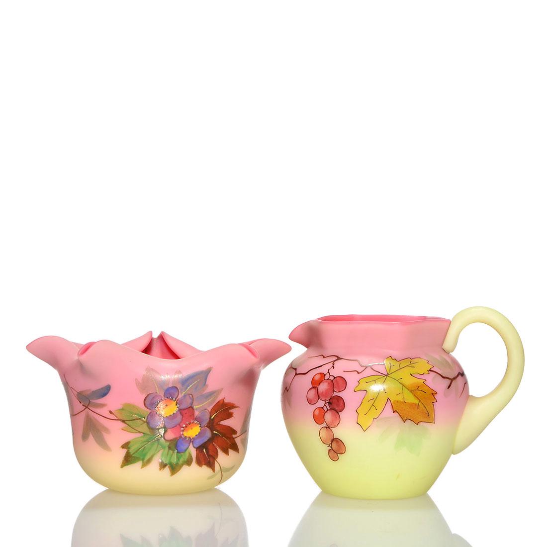 2 Thomas Webb & Sons Burmese: creamer + vase: Two Thomas Webb & Sons acid Burmese, a 2 3/4 inch individual creamer with hexagonal rim and grape and leaf design plus a 2 inch by 4 inch vase with fold-in star rim and colorful flower and leaf design
