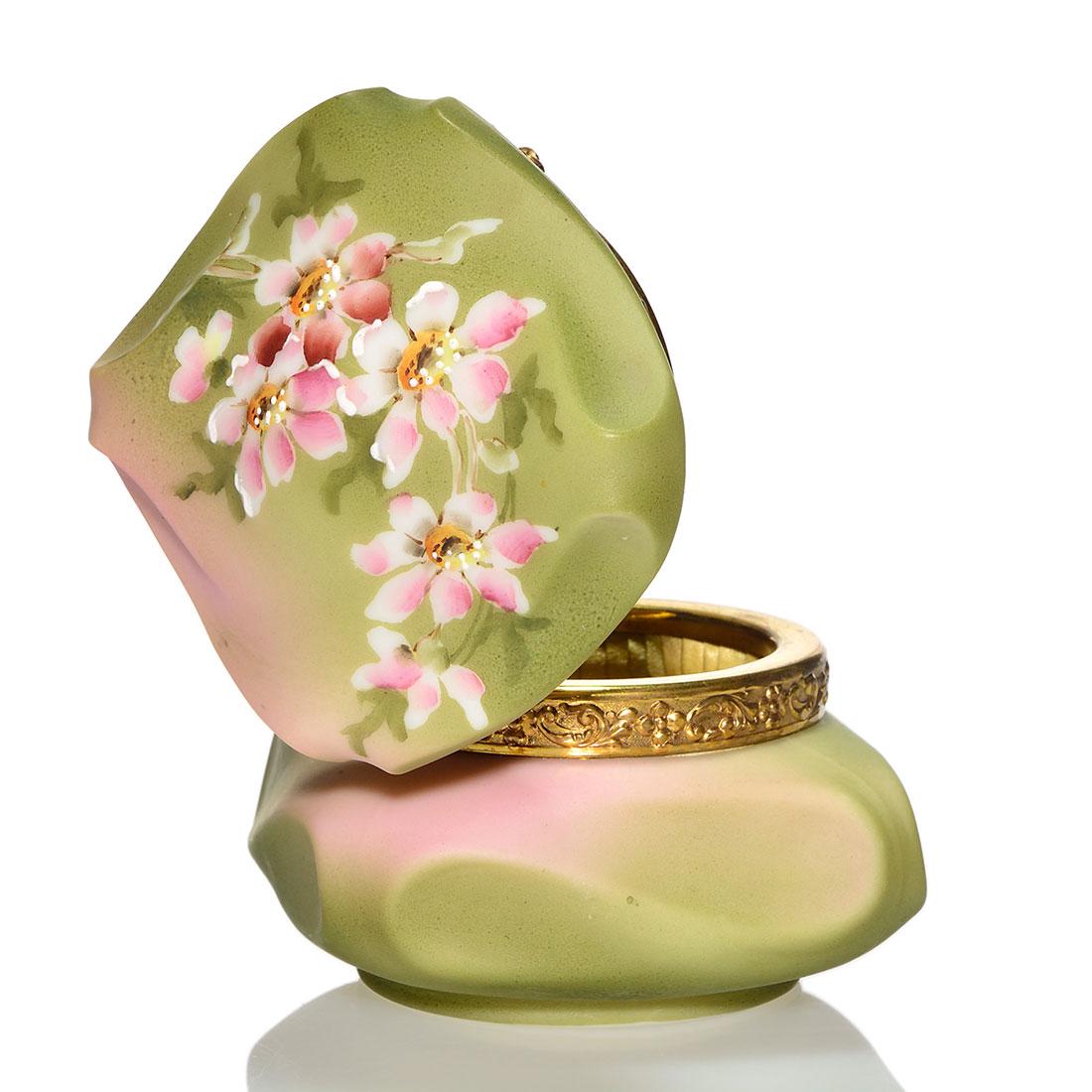 Nakara Bishop Hat jewelry box, wild roses, 3 1/2": Nakara Bishop's Hat jewelry box with pink wild roses on the cover and base against an olive green and pink backdrop. Measures 3 1/2 inches by 3 3/4 inches wide. Stamped C.F.M. Co., Nakara for C.F. Mon
