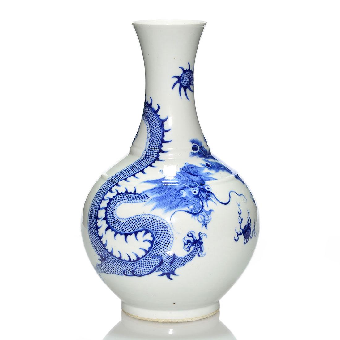 Chinese blue & white Dragon and Peacock vase, 15": Chinese white porcelain vase revealing in cobalt blue a spirited peacock and a noble five claw dragon pursuing a flaming thunder ball. Measures 15 inches by 11 inches across. Six character marks benea