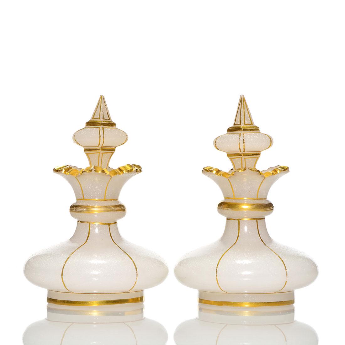 Pr. French opaline perfumes, hand cut, gold, 4 1/2": Pair French opaline perfumes with hand cut scalloped rims and shapely cut stoppers all trimmed in gold. Measures 4 1/2 inches by 3 inches across. The stoppers have nicks to points and bruising to the