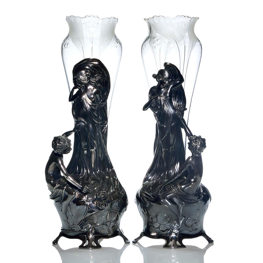Pr. WMF Britannia silverplate, original inserts, 20": Impressive pair WMF Jugendstil, Britannia silverplate vases with original glass inserts. Each metal holder reveals in different poses the seated figure of a partially nude male admirer gifting flowers