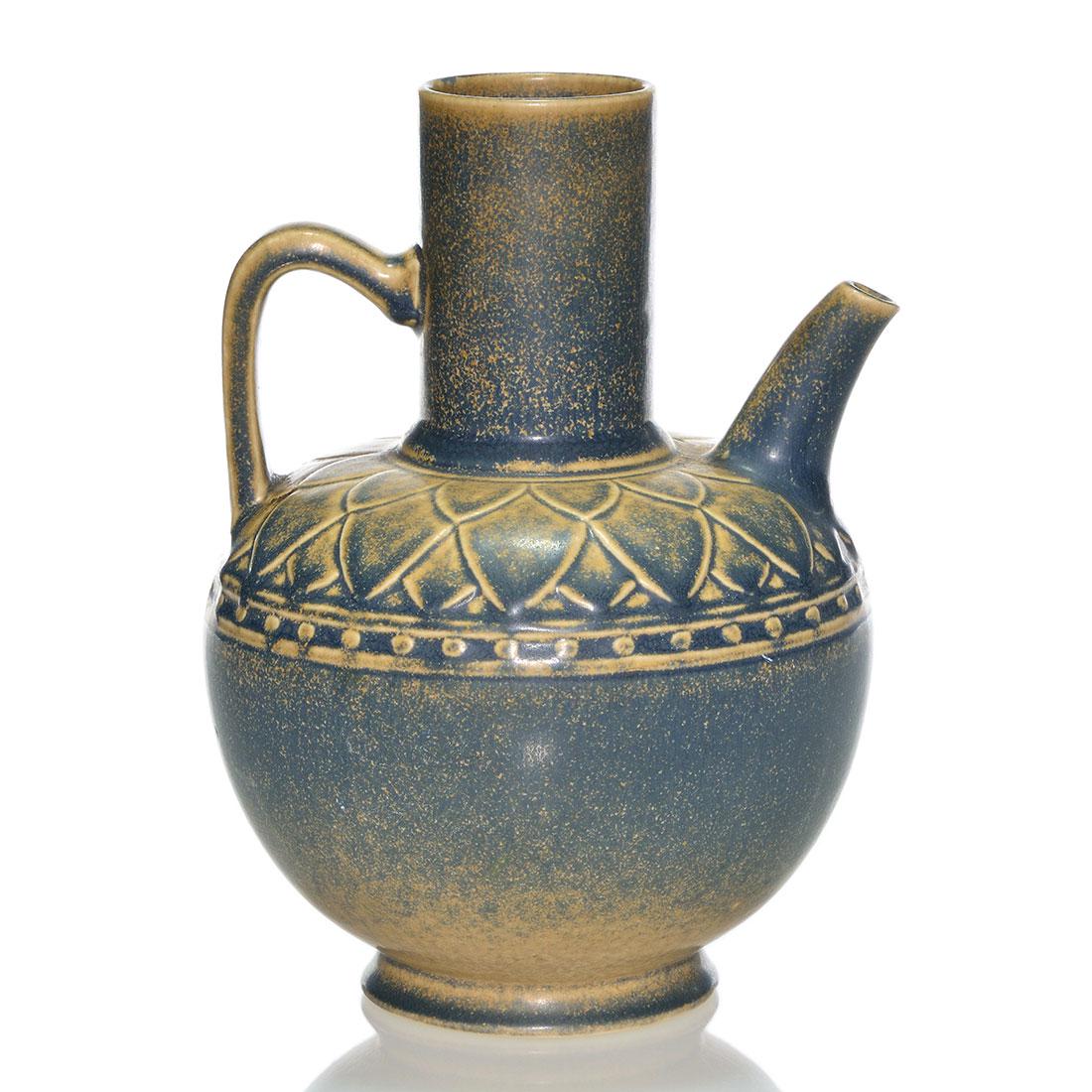 Rookwood water jug, blue-tan, 7 1/2", 1923, 2644: Rookwood Production water jug, the shoulder cloaked by flower petals bordered by beading and covered with the ever popular blue over tan glaze. Height 7 1/2 inches. Impressed with the company logo, 19