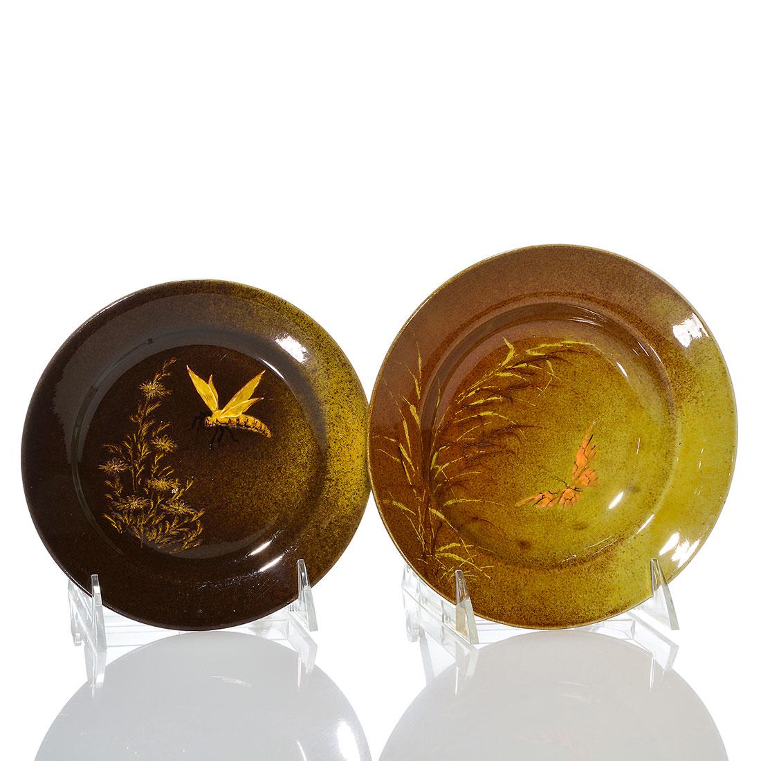 Rookwood 2 Standard plates,1885, McDonald, 202, 6 7/8",: Two Standard glaze plates decorated in 1885 by William McDonald. 1) 6 1/8 inches, shape 202, with a bee moth. Artist's initials in black slip. 2) 6 7/8 inches, with a butterfly. Artist's monogram inci