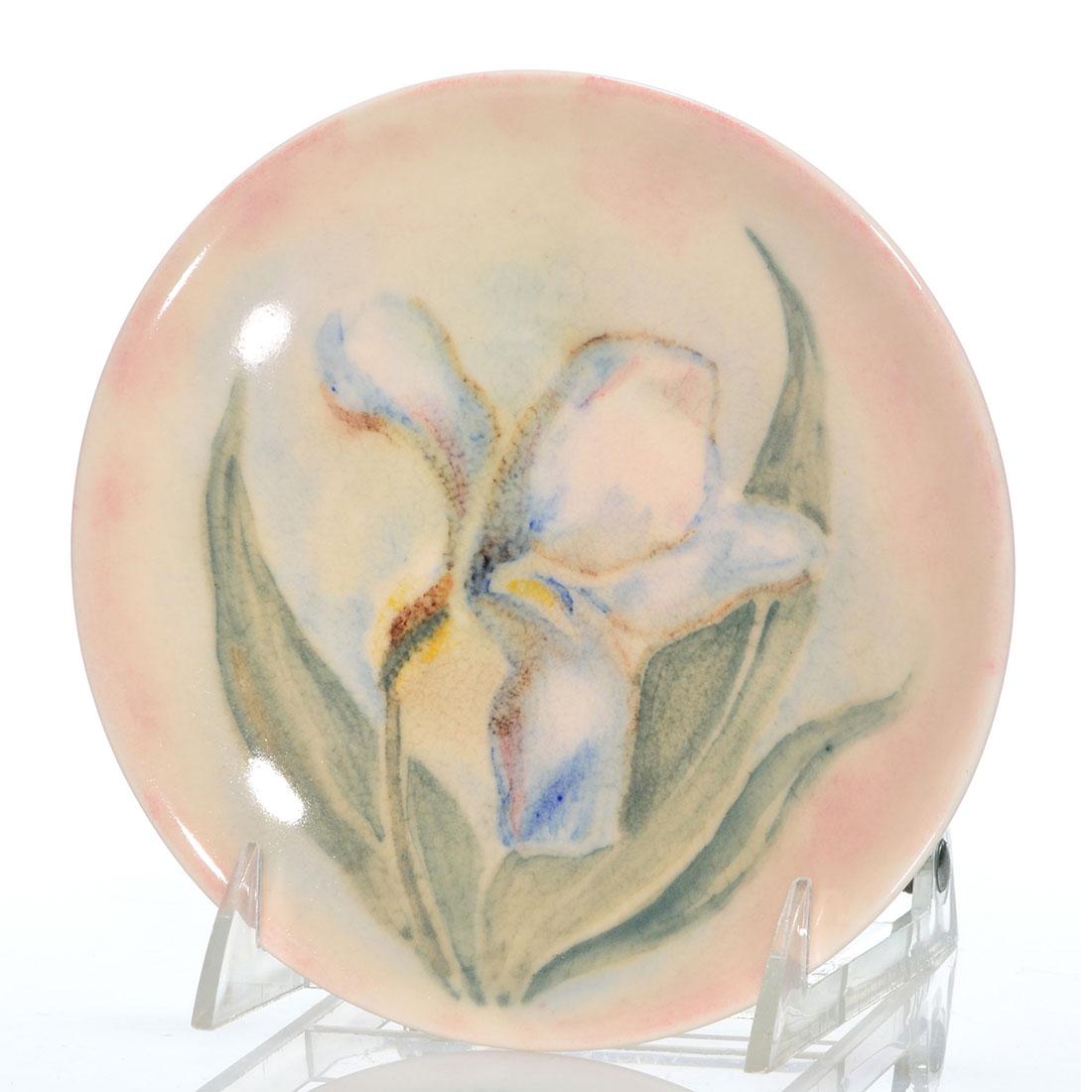 Rookwood Design Crystal plate, Iris, Barrett, 6 1/4": Rookwood 6 1/4 inch diameter plate decorated with a single Iris by Elizabeth Barrett in 1946. Marks include the Rookwood logo, date, shape 6943, Ms. Barrett's monogram and "3296" in black slip. There