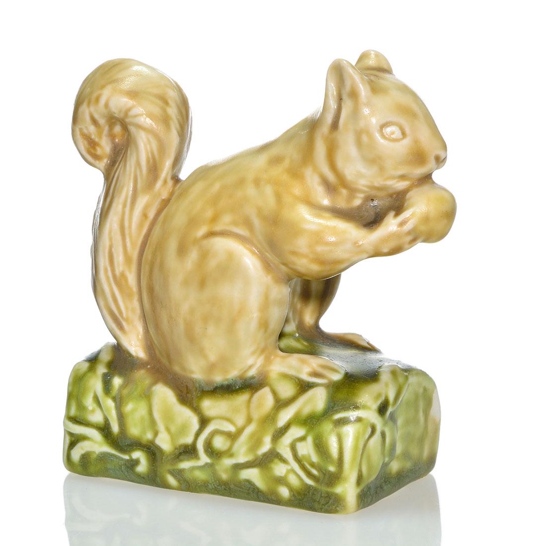 Rookwood Polychromed squirrel pw 1928, 6025, 4 1/8": Squirrel paperweight, a Sallie Toohey design, cast in 1928 and covered in multiple mat glazes. Marks include the Rookwood logo, date, shape 6025 and Ms. Toohey's mold monogram. Excellent original cond
