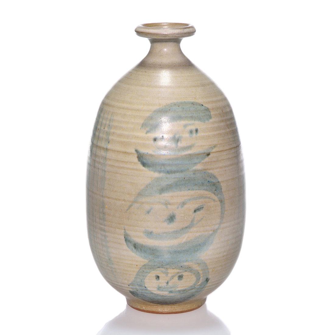 Otto and Vivika Heino shino glaze vase, faces, 7 3/8”: Unusual Otto and Vivika Heino hand thrown vase with Shino-like glaze having three faces stacked one on top of the other on each side of the form. Incised Vivika and Otto monogram. Height 7 3/8 inches.