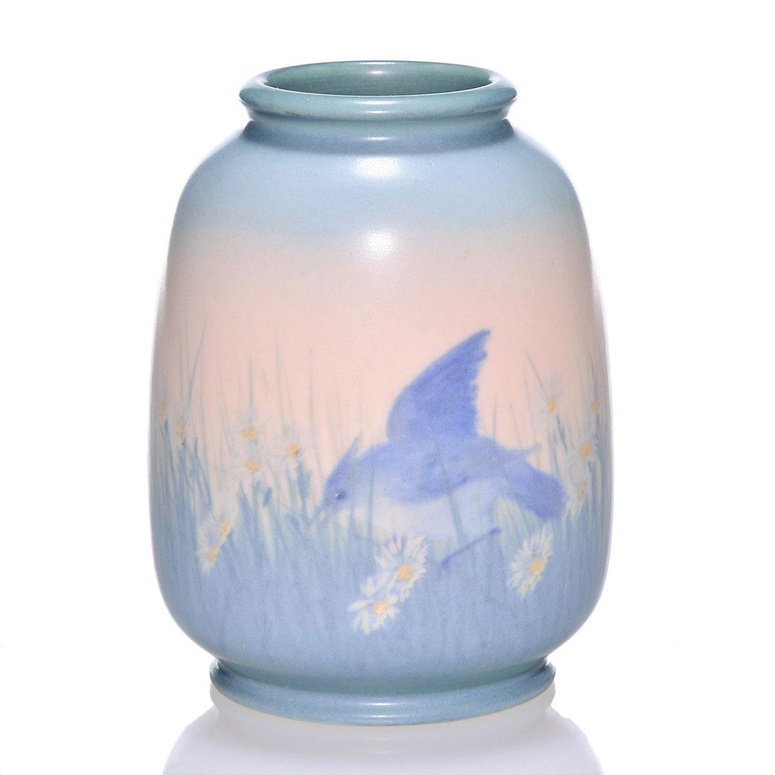 Rookwood Vellum scenic vase, Hurley, 1931,6196E,5 7/8": Vellum Scenic vase showing a pair of blue birds in a field of daisies painted by E.T. Hurley in 1931. Marks include the Rookwood logo, date, shape 6196 E, the fan shaped esoteric mark used during the