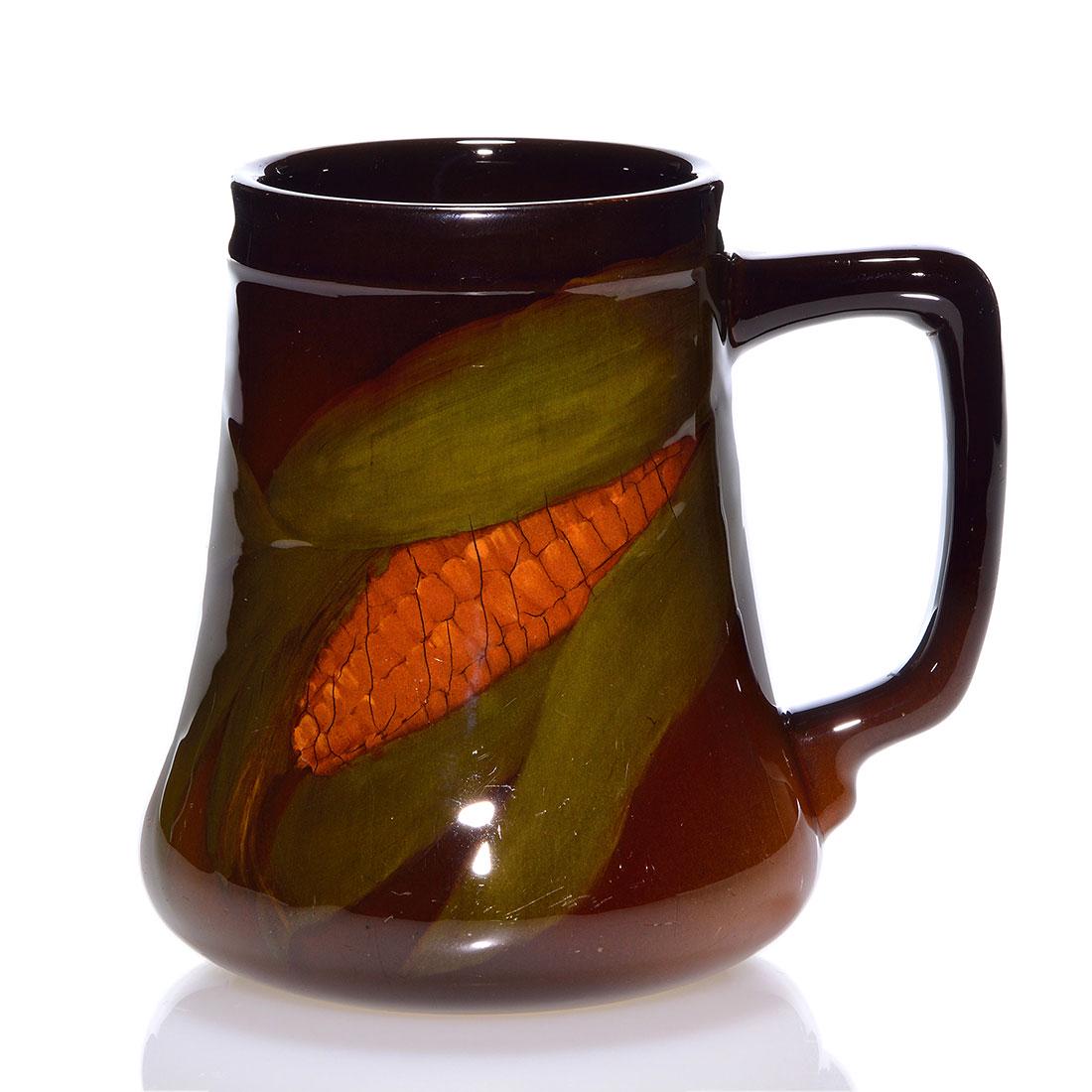 Rookwood Standard mug,Lindeman,1900,656, 4 3/4": Standard glaze mug decorated with an ear of corn painted by Laura Lindeman in 1900. Marks include the Rookwood logo, which indicates the date, shape 656 and Ms. Lindeman's incised initials. Uncrazed b