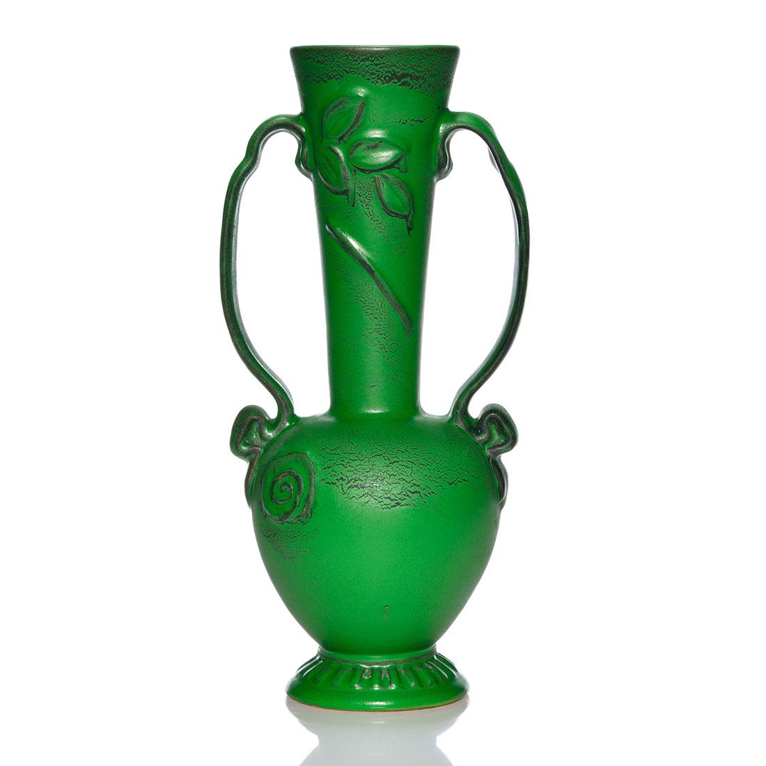 Unusual Weller twin handled vase, green mat, 10 3/4": Unusual Weller twin handled vase with leaves and a single swirl on one side done, possibly by Dorothy England. Done in a vibrant green mat glaze with black highlights, the vase is signed in script, We