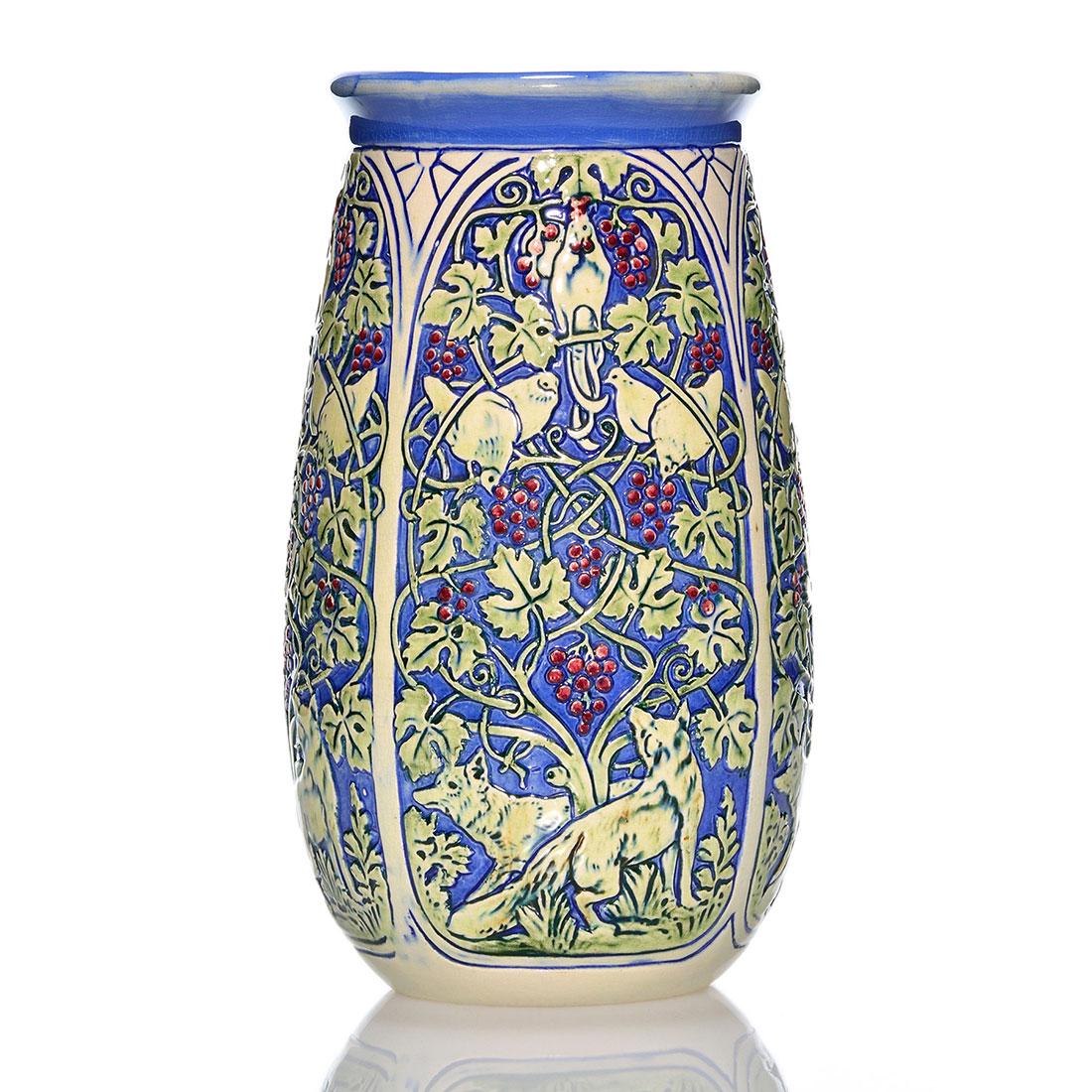 Weller Knifewood vase, birds, grape vines, foxes, 10": Weller Knifewood vase with birds feasting within a grapevine tangle, observed by a pair of foxes. Height 10 inches. Unmarked. Tiny rim nick, otherwise, excellent condition. Wonderful glaze.