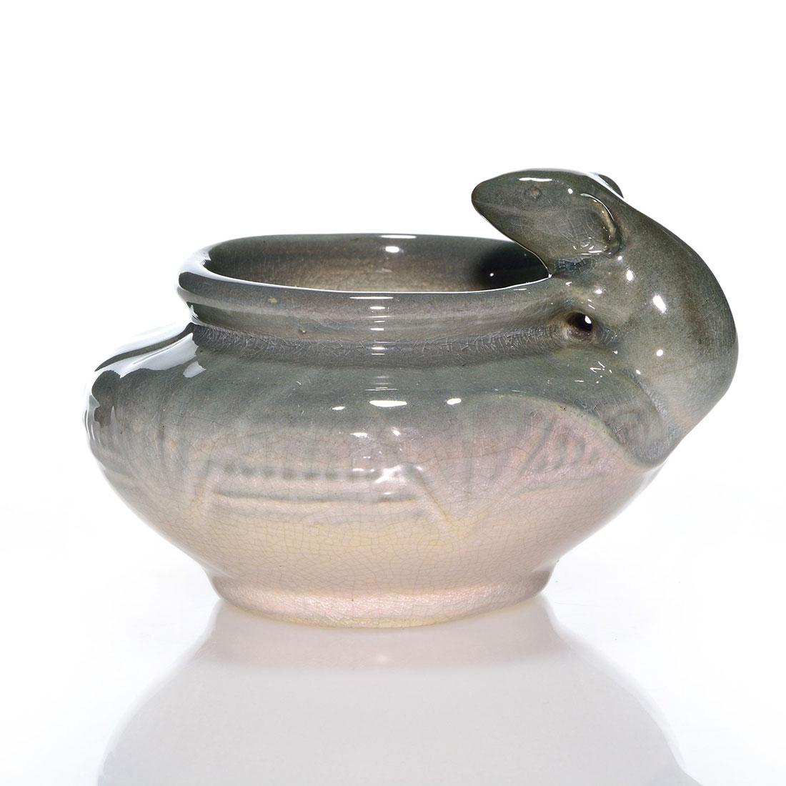 Weller Etna vase, mouse, 2 3/4 inches: Weller Etna vase with a mouse climbing over the shoulder. Impressed WELLER in small block letters on the bottom. There is fine overall crazing and a small nick at the rim. Height is 2 3/4 inches.