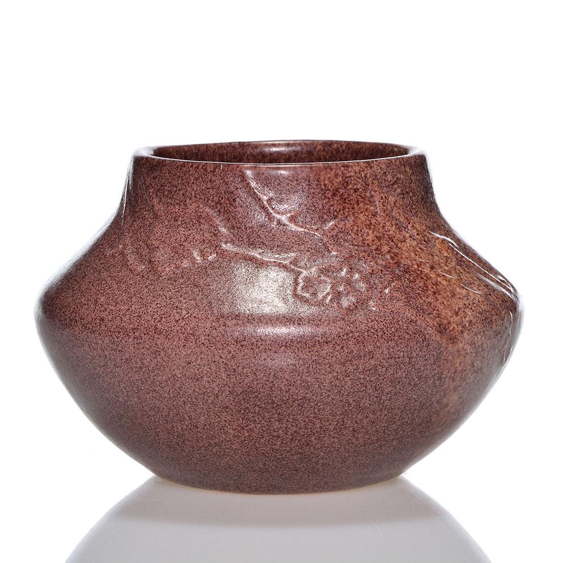 Arequipa low vase, carved flowers, 4": Artist signed Arequipa vase with carved leaves and vines done in a speckled rust and tan mat glaze. Signed with the Arequipa logo along with incised initials that appear to be GS. Also incised are the