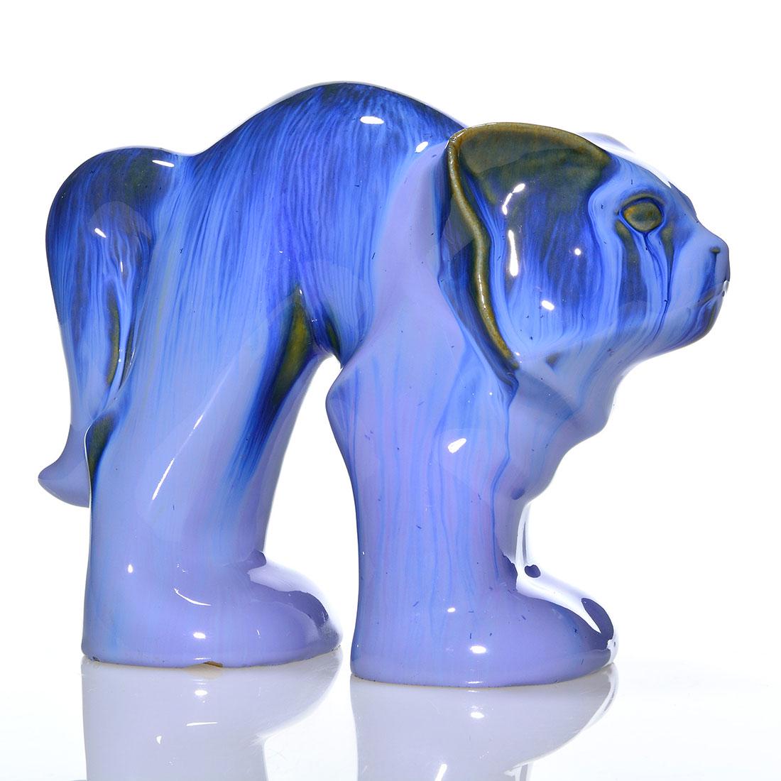 Fulper Cat Doorstop, blue flambe', 6 7/8": Fulper Pottery cat doorstop covered in a blue flambe' glaze with tan highlights. Impressed FULPER in block letters on the base. There is a minor stilt pull that is barely visible from the side and som