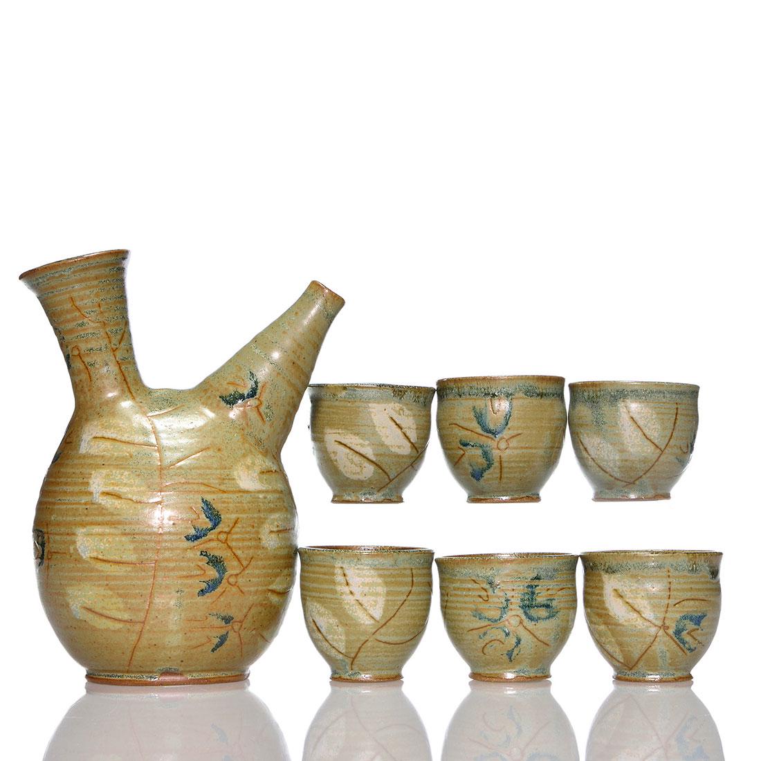 Frances Senska 8 3/4" carafe + 6 tumblers, 2 5/8": Frances Senska 8 3/4 inch spirit carafe plus six 2 5/8 inch tumblers, matching in design and glazes. The carafe, marked FS, is pictured and discussed in "Alternative American Ceramics 1870-1955" by Ke