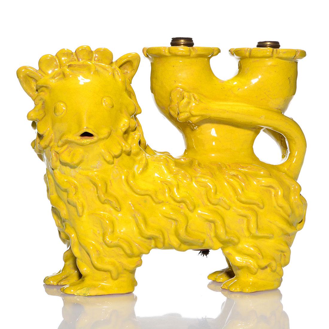 Kitty Rix Lion lamp for Weiner Werkstatte, 7 1/2": Kitty Rix, a hand modeled Lion lamp figural under a bright yellow glaze for Weiner Werkstatte. Measures 7 1/2 inches tall and 10 inches in length. Glazed chips on two front toes and mouth. Crazing. Im