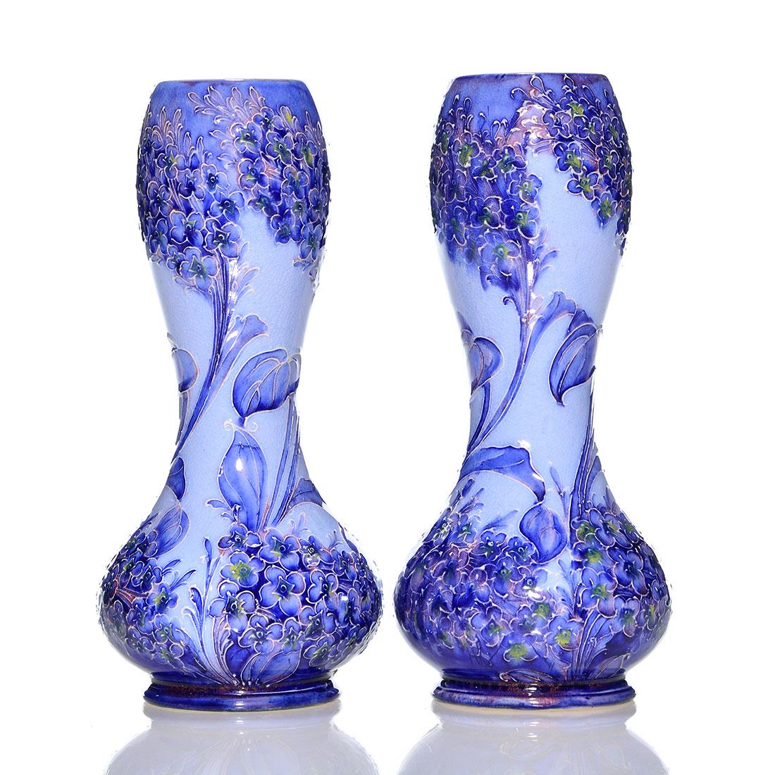 Pair Moorcroft Florian vases, lilacs, 7", marks: Pair of Moorcroft Florian Macintyre vases with branches of lilacs all around. Heights are 7 inches. Each are brown stamped with the Florian Ware Macintyre logo and W. Moorcroft in green slip. Fine cra
