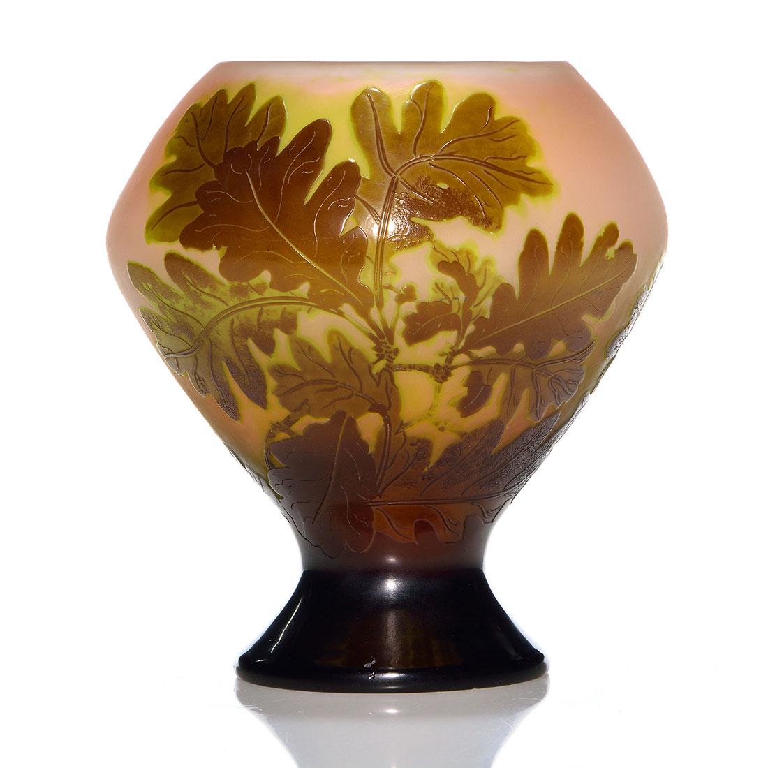 Galle cameo vase, oak boughs, signed, 6": Galle cameo shouldered vase displaying boughs of oak leaves about the circumference mostly in brown with touches of sage green. The apricot backdrop bears Oriental-style Galle cameo signature. Showy a