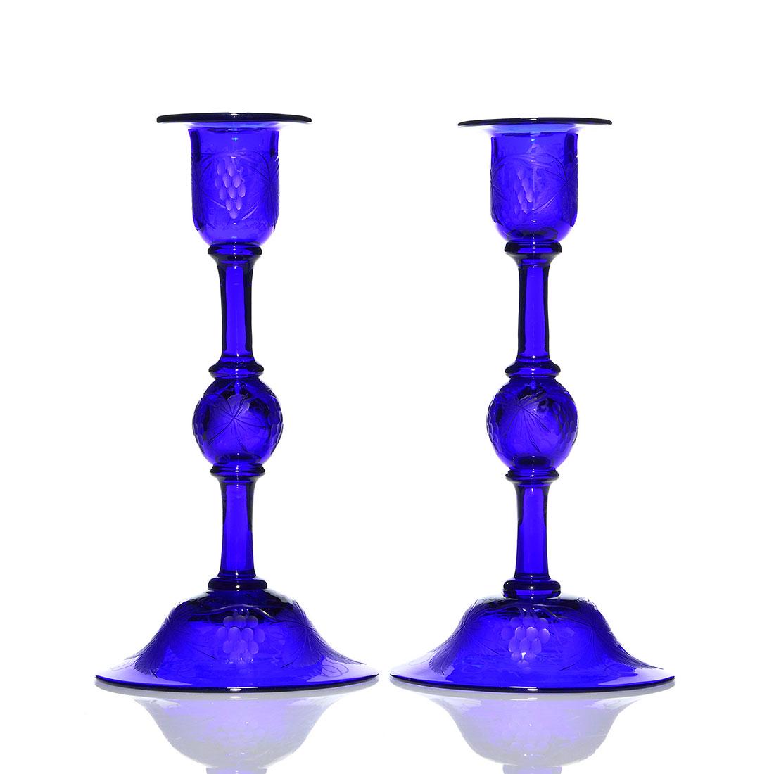 Pr. Pairpoint cobalt candleholders, engraved, 9 3/4": Pairpoint pair of cobalt blue candleholders displaying frosted wheel engravings of grapes on the vine. Heights are 9 3/4 inches. Consider the steady hand to connect the five sections and engraving the