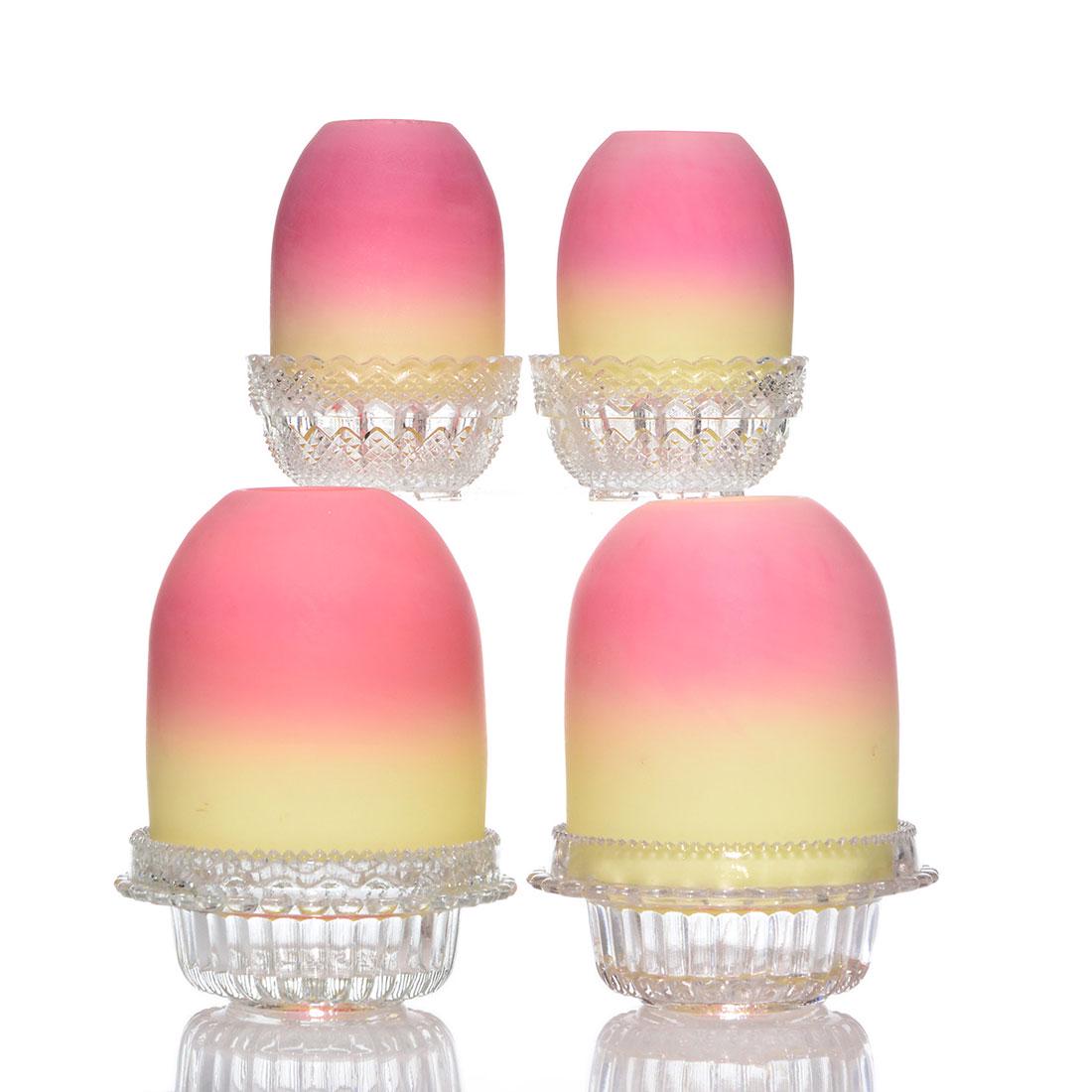 4 Thos Webb Burmese fairy lamps, 2 are Pyramid: Four Thomas Webb & Sons Burmese fairy lamps on S. Clarke clear pressed bases. Twin 2 1/2 inch Pyramid shades, rough or chipped lower edges, on relief diamond bases, combined heights 3 3/4 inches. Pair