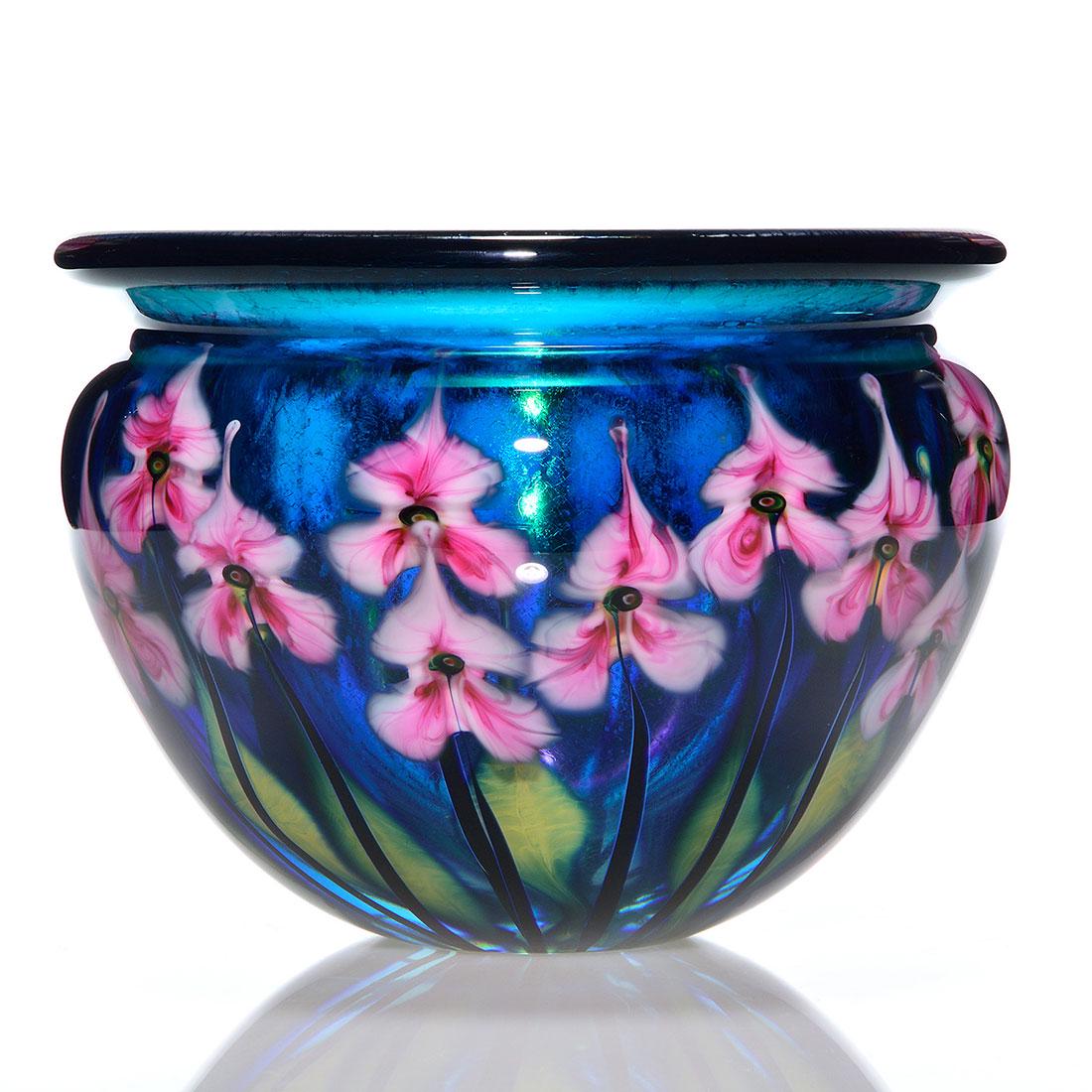 John Lotton Paperweight vase, floral, 7"X9 1/2", 1997: John Lotton Paperweight Copper blue vase revealing two layers of pink and white trillium above two layers of custard blue foliage. The interior has a nice rainbow reflection and a craquelle-like finis
