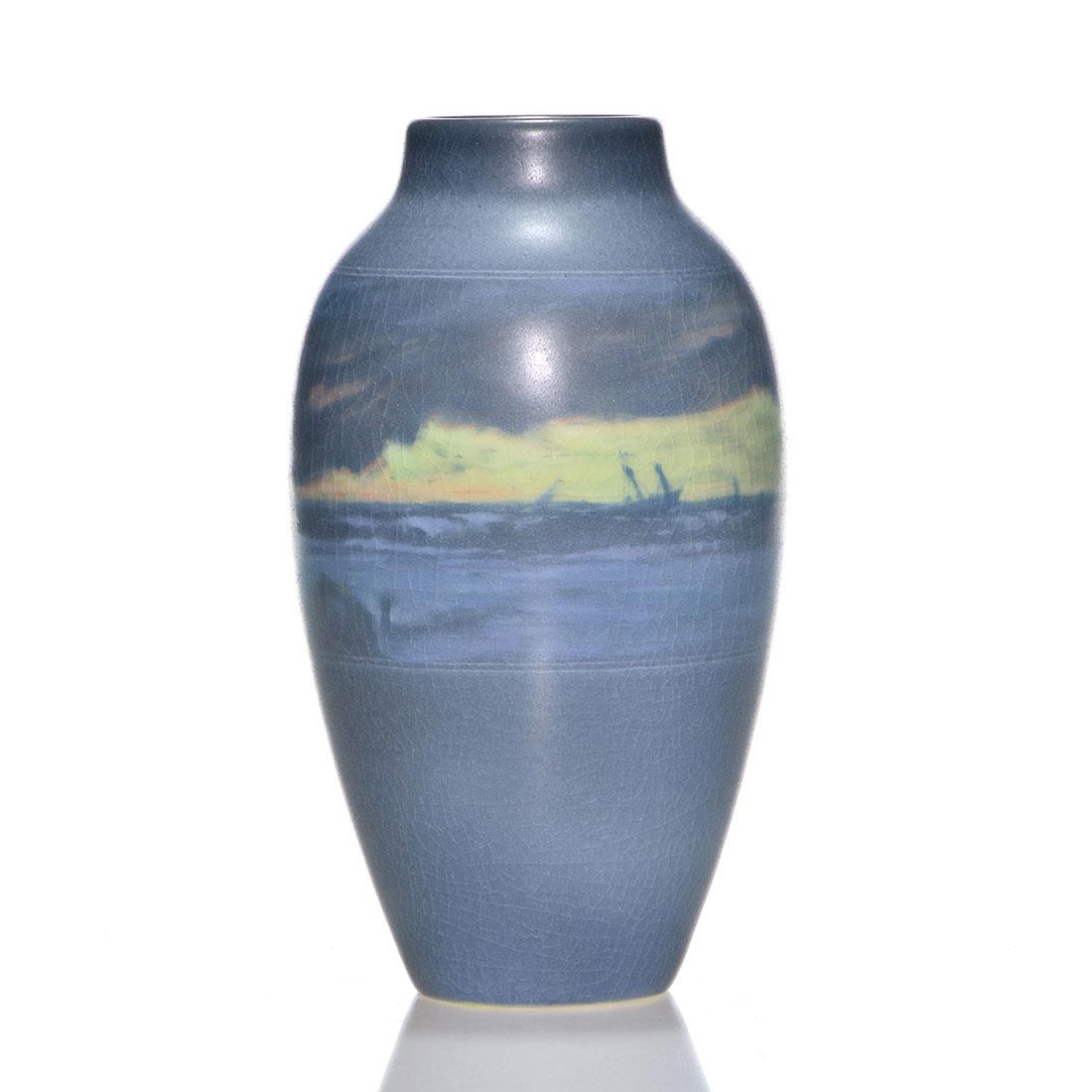 Rookwood Vellum, Rothenbusch, shipwreck, 1910, 6 3/4": Unusual banded scenic Vellum vase showing a sailing vessel run aground on the rocky shoreline during a storm, the work of Fred Rothenbusch in 1910. Marks include the Rookwood logo, date, shape 900 D, 