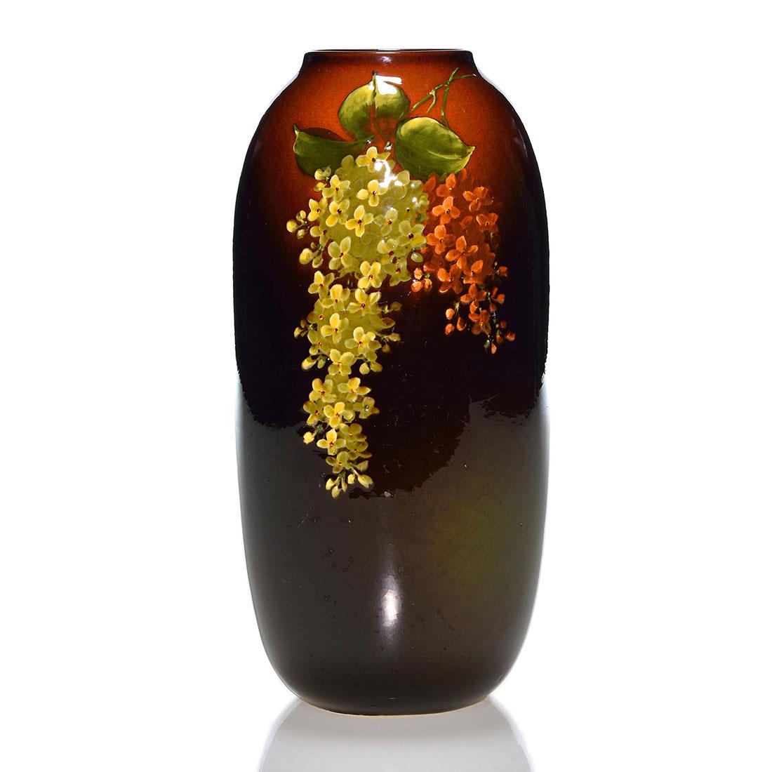 Weller Louwelsa vase, lilacs, John J Herold, 8 5/8": Weller Louwelsa vase with lilac decoration painted by John J. Herold who added his signature in slip on the side. Impressed Louwelsa Weller, 555, K and 7. There is fine overall crazing. Height is 8 5/
