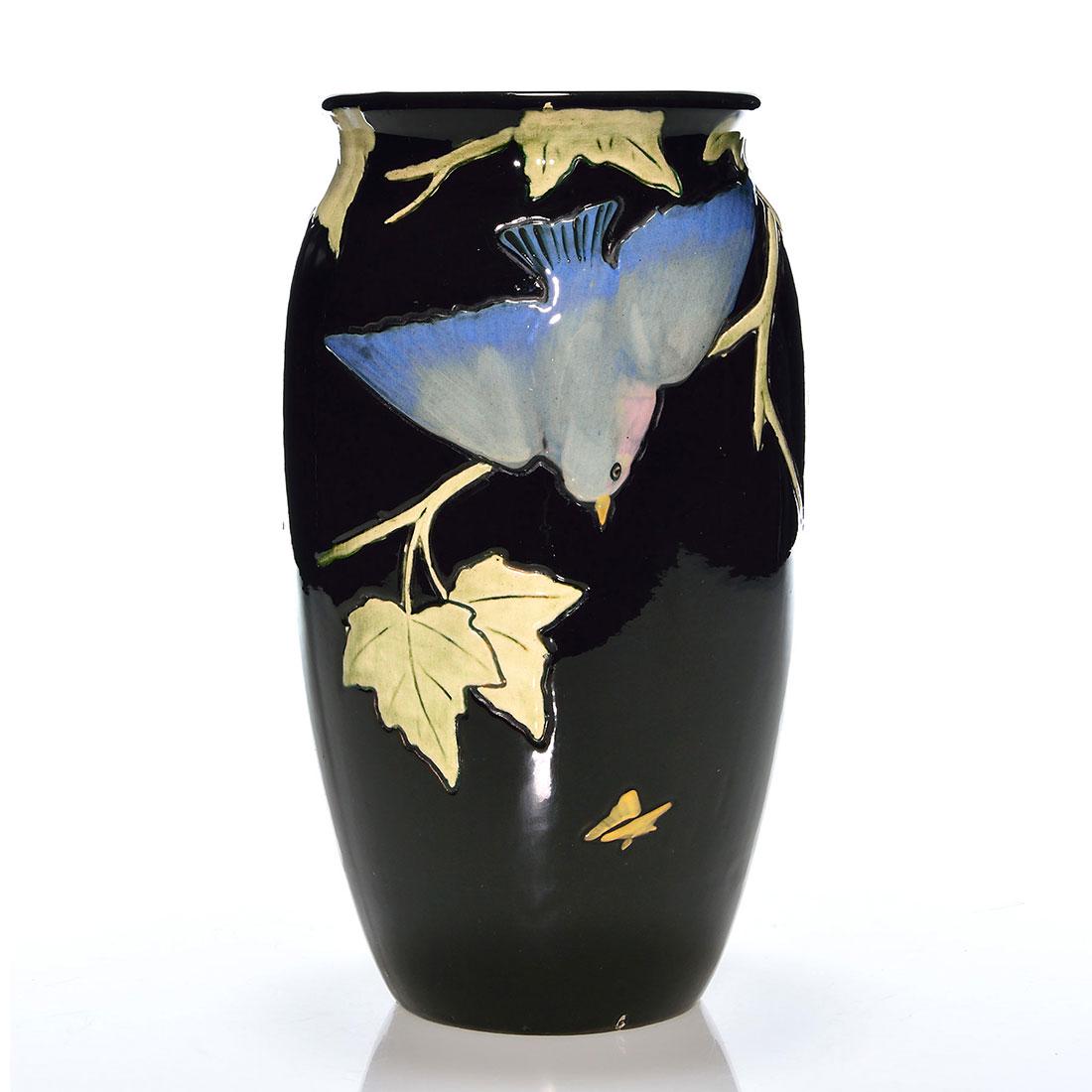 Weller Rosemont vase, bluebirds, 10 1/2”: Weller Rosemont vase (the larger size) showing a pair of bluebirds in pursuit of moths. Impressed WELLER in block letters. There is faint crazing and some minor nicks at the base. Height is 10 1/2 inc