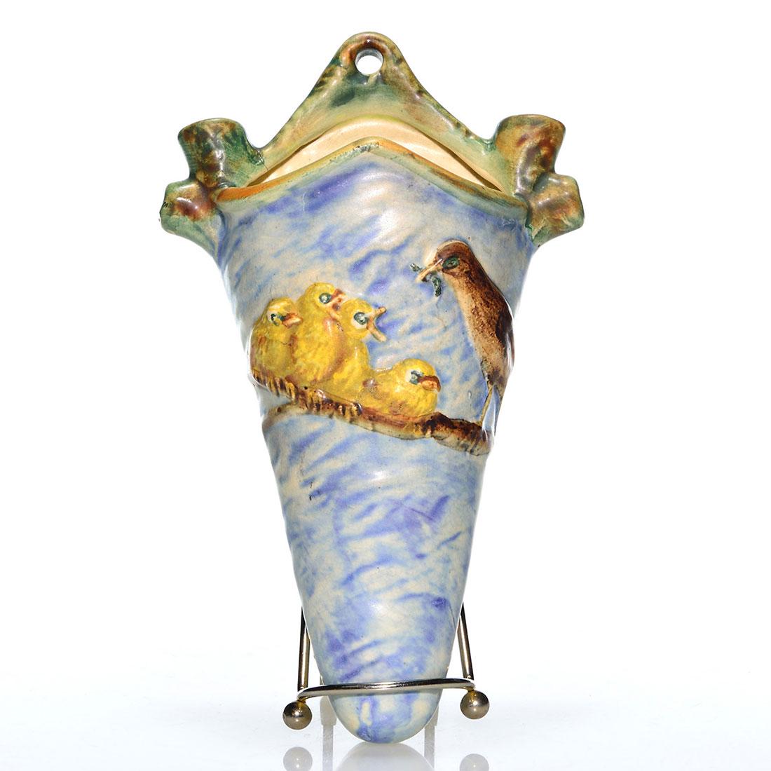 Weller Glendale wall pocket, robin, baby birds, 9 1/4": Weller Glendale wall pocket flanked by branch flower arrangers, the front having a robin with food and 4 hungry baby birds perched on a branch. Height 9 1/4 inches. Stamped Weller Ware. There is faint