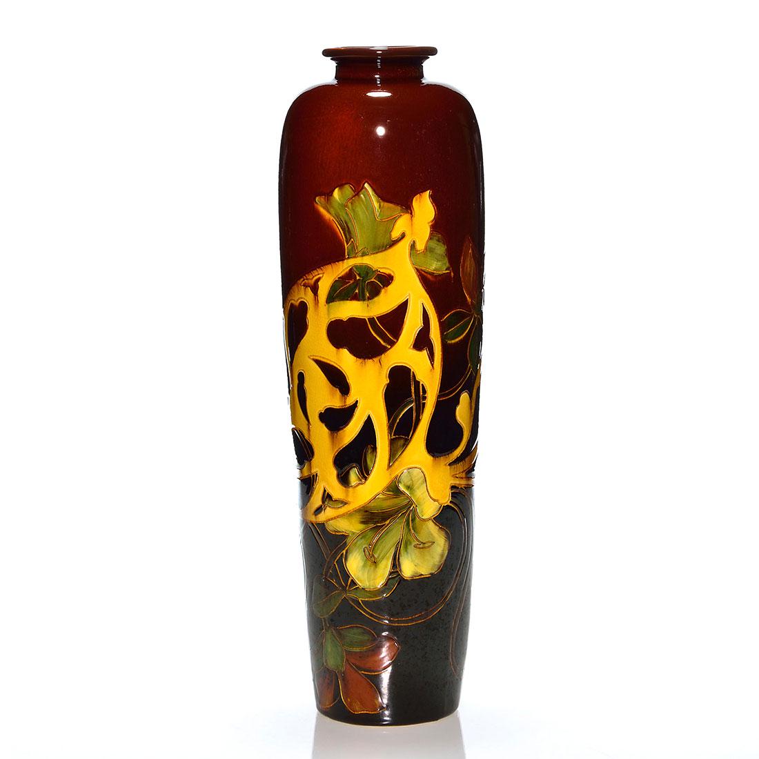 Weller Dickens Ware 1st Line tall vase, lilies,16 1/8": Tall Weller Dickens Ware First Line vase with day lily decoration. Impressed numbers on bottom 568 and 9. There is fine overall crazing and tiny, open bubbles in the glaze. Height is 16 1/8 inches.