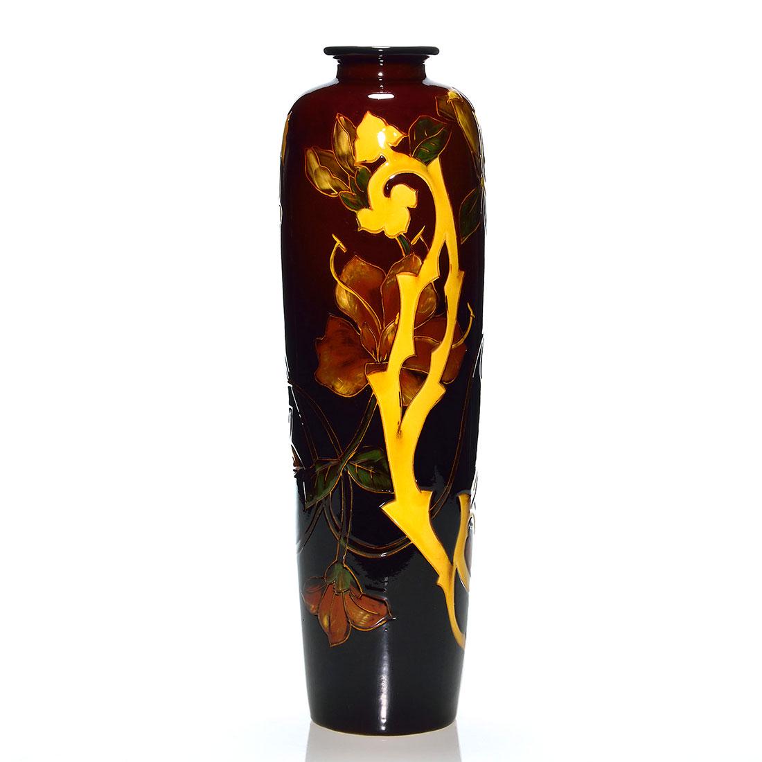 Weller Dickens Ware 1st Line tall vase, lilies, 16 3/8": Tall Weller Dickens Ware First Line vase with day lily decoration. Impressed numbers on bottom appear to be 568. There has been professional repair leaving the entire vase over-sprayed. Height is 16 3