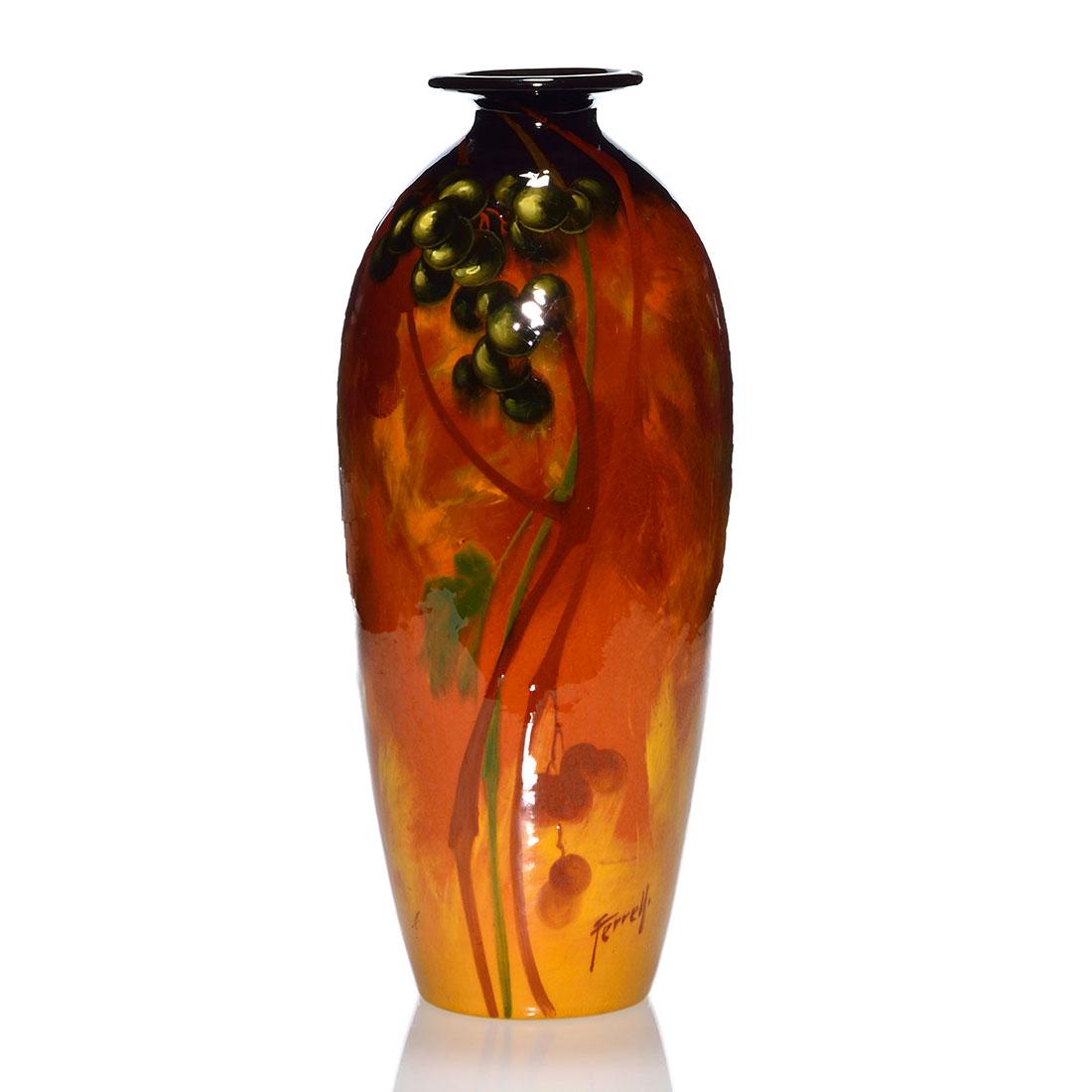 Weller Aurelian vase, grapes, 15 3/8”, Ferrell: Tall Weller Aurelian vase with blue grapes on the vine painted and boldly signed by Frank Ferrell. Height 15 3/8 inches. Incised Aurelian Weller and impressed 345 X on the bottom. There is overall cra