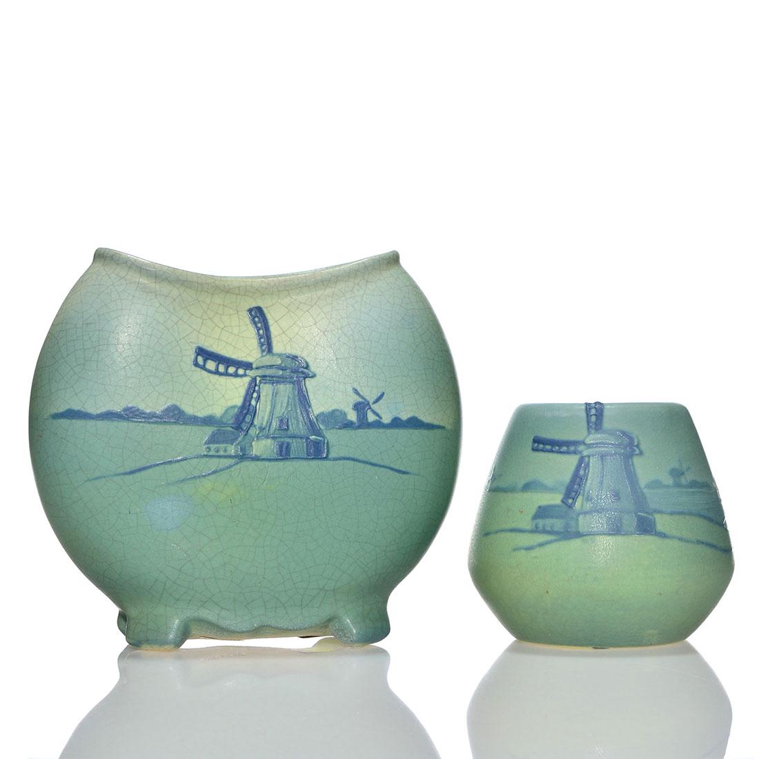 2 Weller Dresden vases, 7 3/4” and 4 3/4”: Two Weller Dresden vases. 1) Pillow vase with windmills and sailboats. Height 7 3/4 inches. Dark crazing. Incised Weller Mat on bottom. 2) Similar vase only 4 3/4 inches tall. Impressed 9055 on bottom
