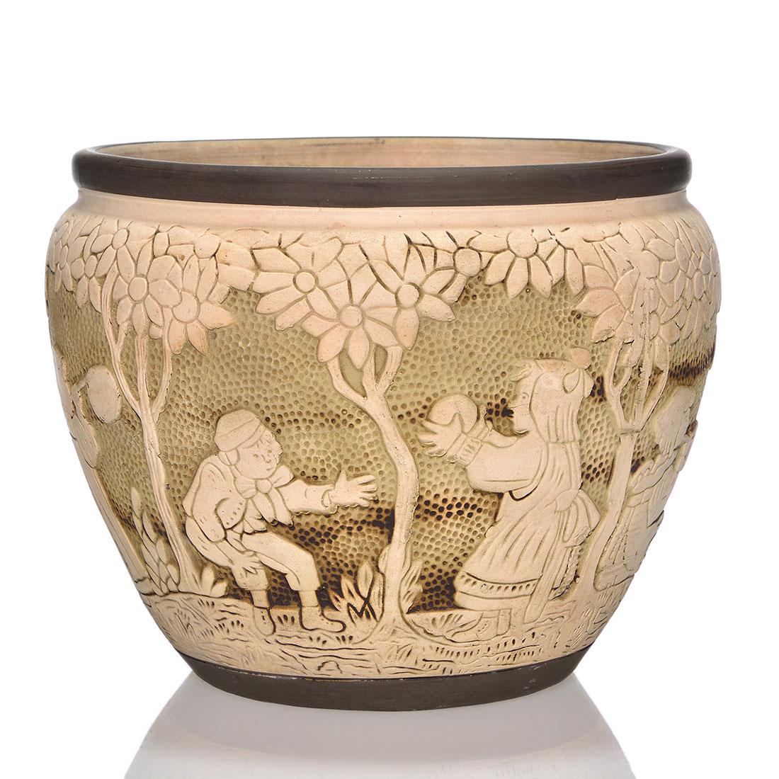 Weller Dechiwo jardiniere, children, 8”: Weller Dechiwo jardiniere showing Victorian children blowing bubbles beneath a canopy of trees, circa 1907. Impressed WELLER on the bottom. There is minor roughness at the base. Height is 8 inches.