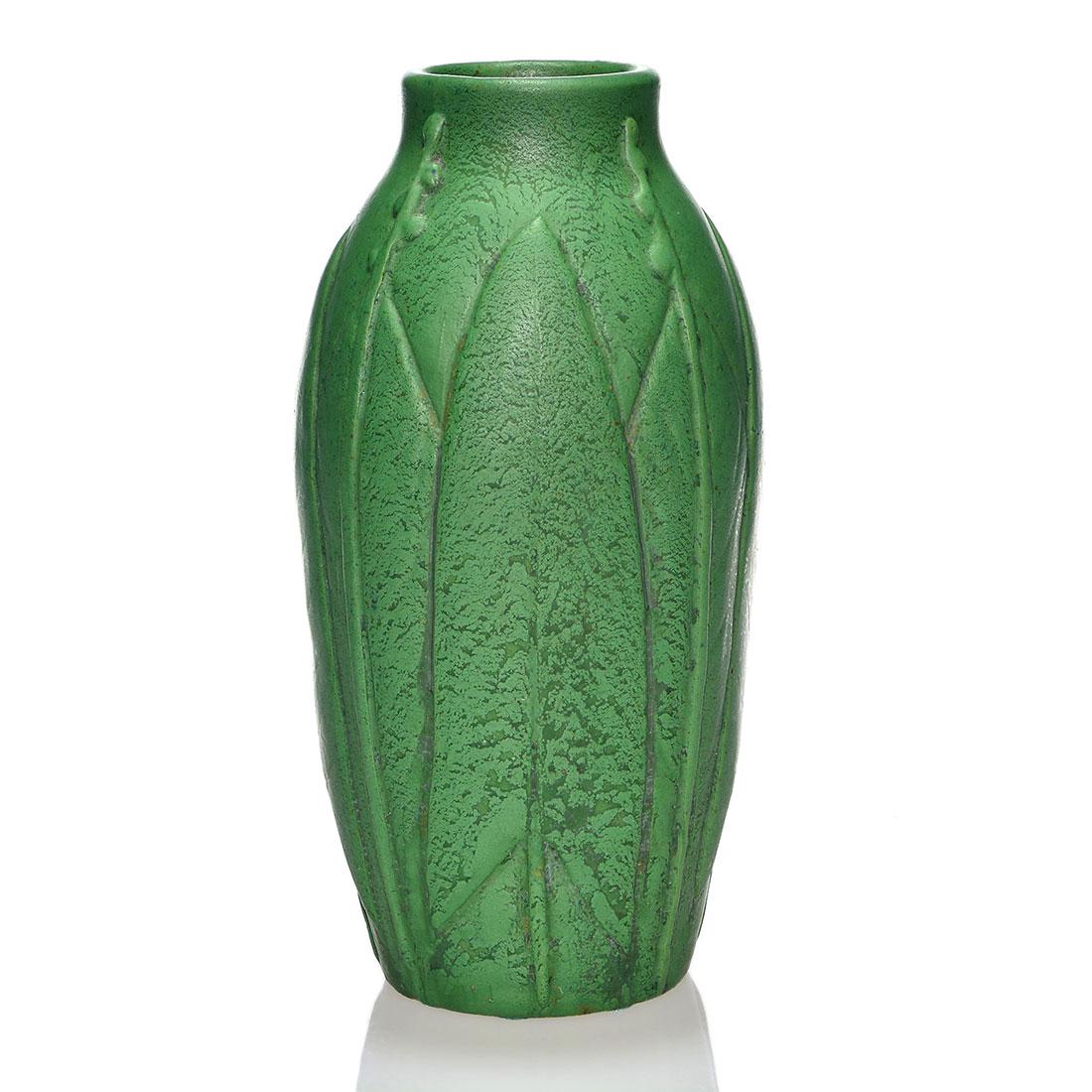 Wheatley green mat vase, arrowhead plants, 12 1/2”: Wheatley Pottery vase with molded arrowhead plant design and covered with a nice, leathery green mat glaze. Marked on the bottom with the Wheatley logo and 629. Excellent original condition with a cou