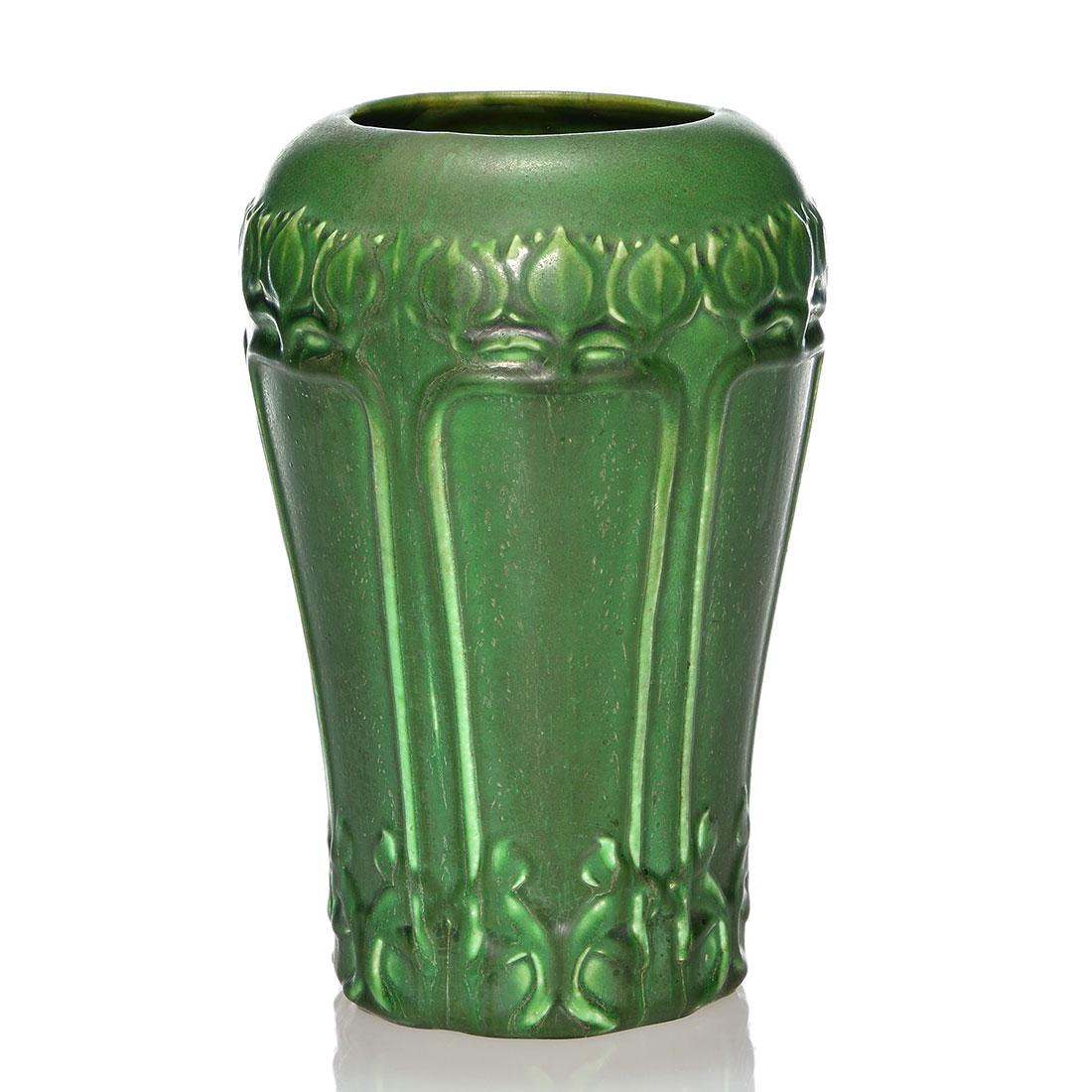 Hampshire vase, floral design, 8 3/4”: Hampshire Pottery vase with intricate floral design and covered with a green mat glaze. Incised Hampshire Pottery and having the Emoretta mark on the bottom. There is a tight 3 inch line at the rim. H