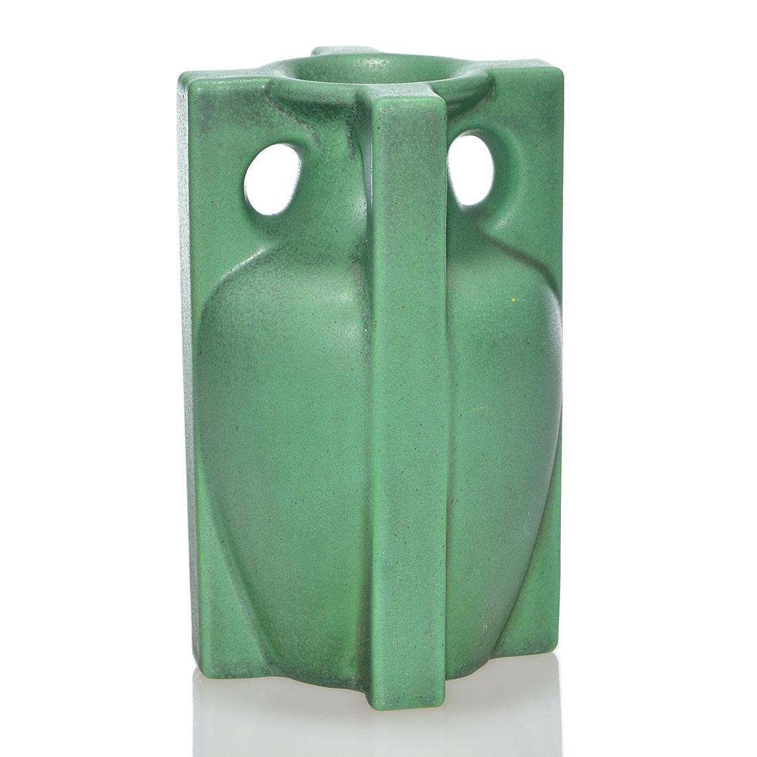 Teco vase, 4 buttress handles, green mat, 7”: Teco vase with four buttress handles covered in a green mat glaze with nice charcoaling. Impressed on the bottom twice with the Teco logo. Excellent condition. Height is 7 inches.