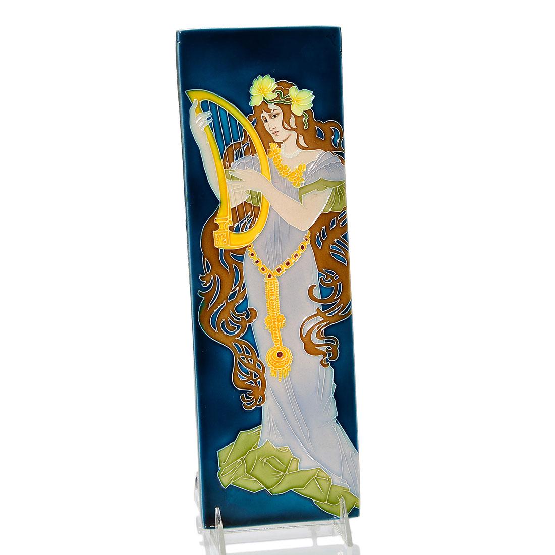 Von Schwarz tile, Luber, harp player 14 1/4" x 4 5/8": Crisp Johann Von Schwarz tile, a Carl Luber design, showing an Art Nouveau woman with long hair, strumming a lute. Marked only with incised numbers on the back. Size is 14 1/4 by 4 5/8 inches. Uncraze