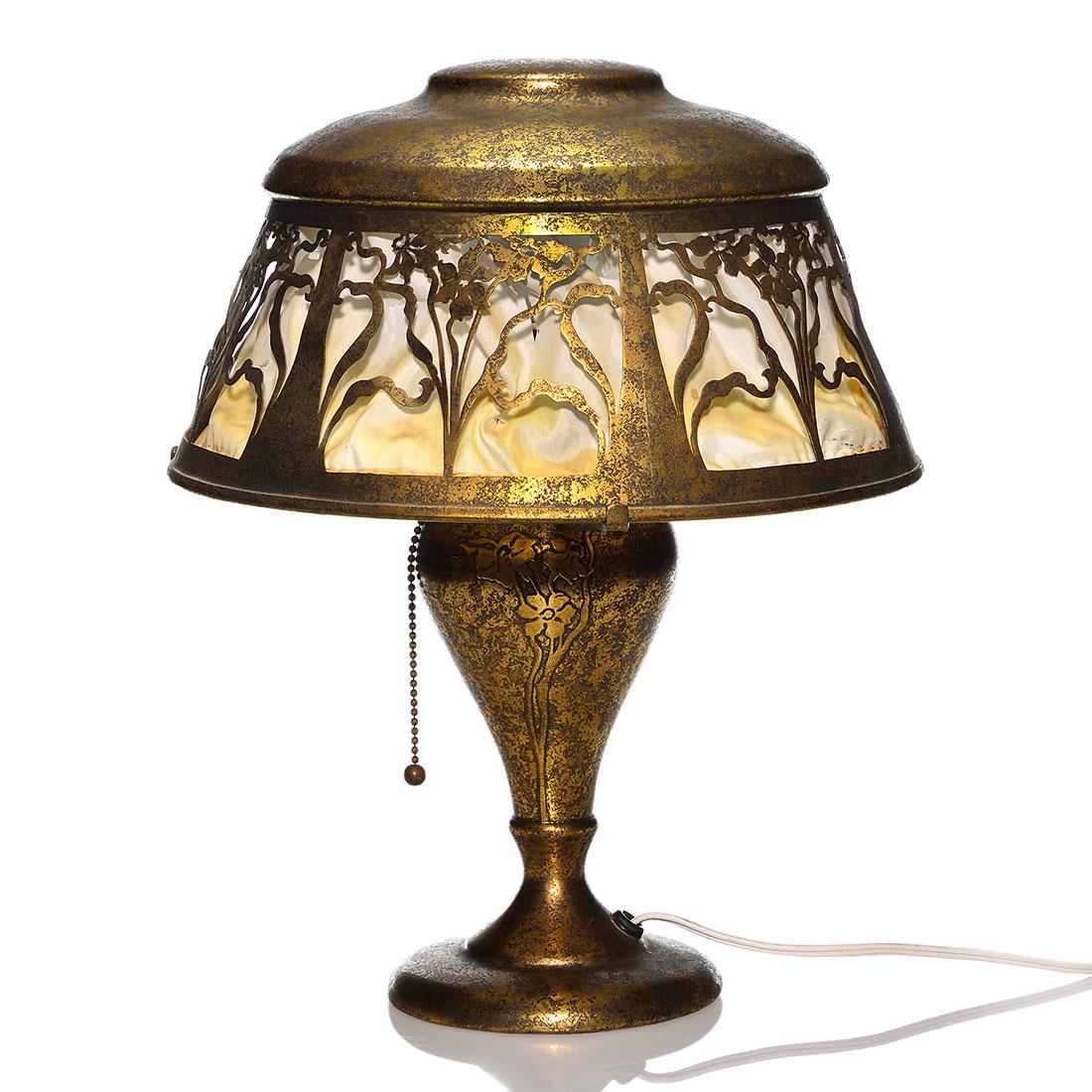 Heintz Art Metal lamp, gilt bronze, 15" tall: Large Heintz Art Metal lamp done in gilt bronze finish with the same floral pattern seen as cut outs in the shade applied to the base. Unmarked with original felt bottom. Height is 15 inches and diame