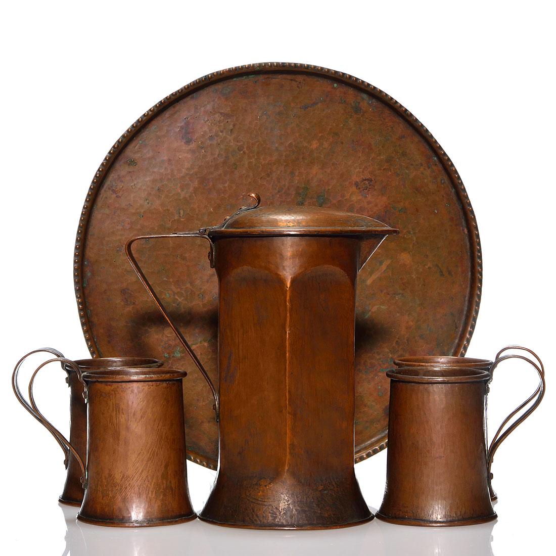 Arts & Crafts copper Ale set, tankard, 10": Arts & Crafts copper ale set with hammered surfaces consisting of a large 10 inch tankard with hinged cover and wide ribbed body measuring 5 1/2 inches across the base. Four mugs rising 4 1/2 inches h