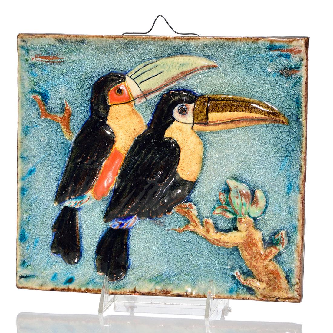 Majolika-Manufaktor Karlsruhe tile by Hugo Ruf,9" x 10": Majolika-Manufaktor at Karlsruhe tile with a pair of colorful toucans, a design by Hugo Ruf circa 1936. Done in a crackle glaze on red clay, the birds and branches they stand on are in high relief. Im