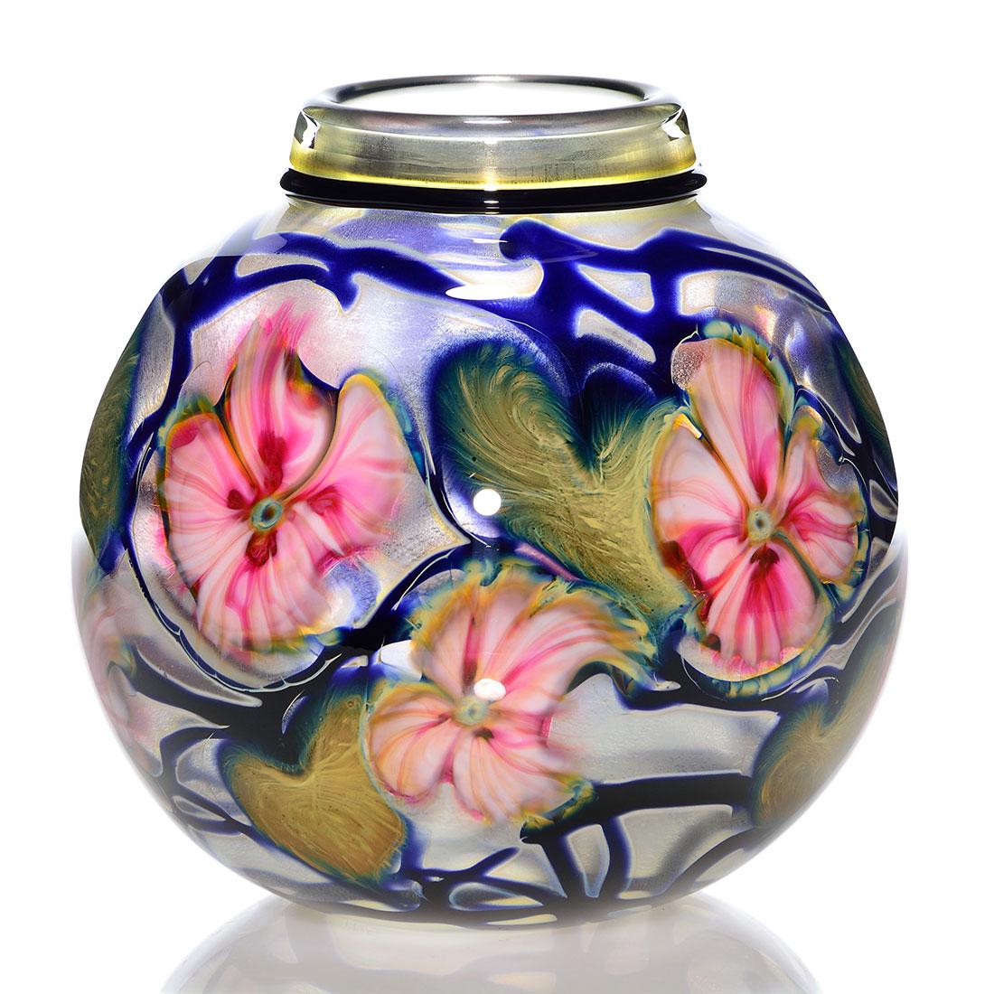 Charles Lotton vase, VDS, pink Multi Flora, 8": Charles Lotton Verre de Soie Multi Flora vase with large pinky white flower heads amid olive green foliage on cobalt blue vines. Tight rolled down collar with a black lip wrap edge. Measures 8 inches 