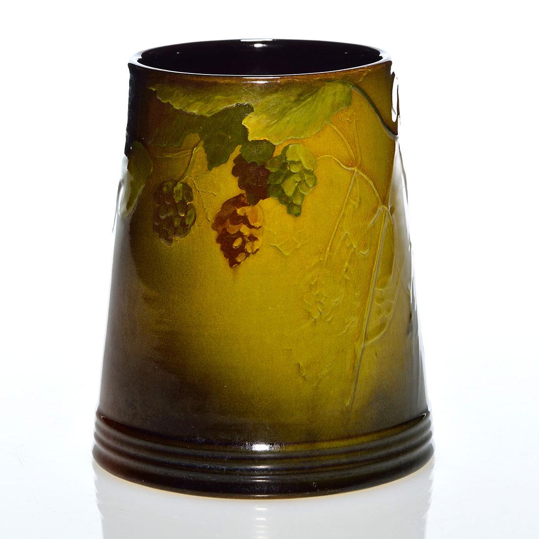 Rookwood Standard mug, hops, 4 3/4”, Hurley, 1897: Standard glaze mug with hops on the vine done by E.T. Hurley in 1897. Height 4 3/4 inches. Impressed with the Rookwood logo, which indicates the date, shape 587 B and the incised monogram of the artis