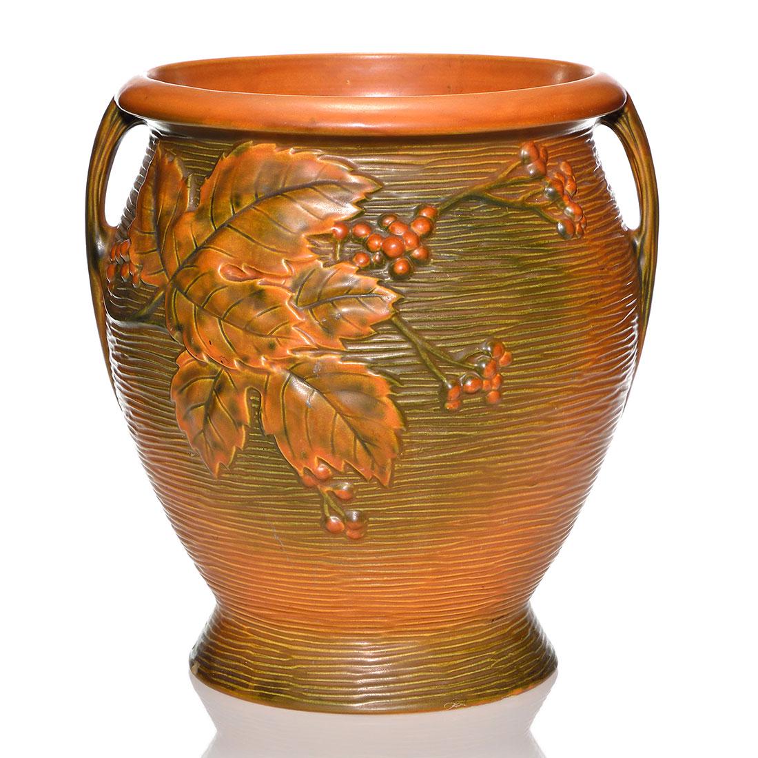 Roseville Bushberry sand jar, 14”, shape 778,: Bushberry Sand Jar, shape 778-14, in brown. Mold marked Roseville U.S.A. 778-14” beneath. There are a few small chips at the base. Height is 14 inches.